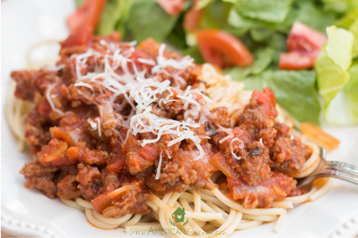 plate of spaghetti and salad with savory spaghetti sauce