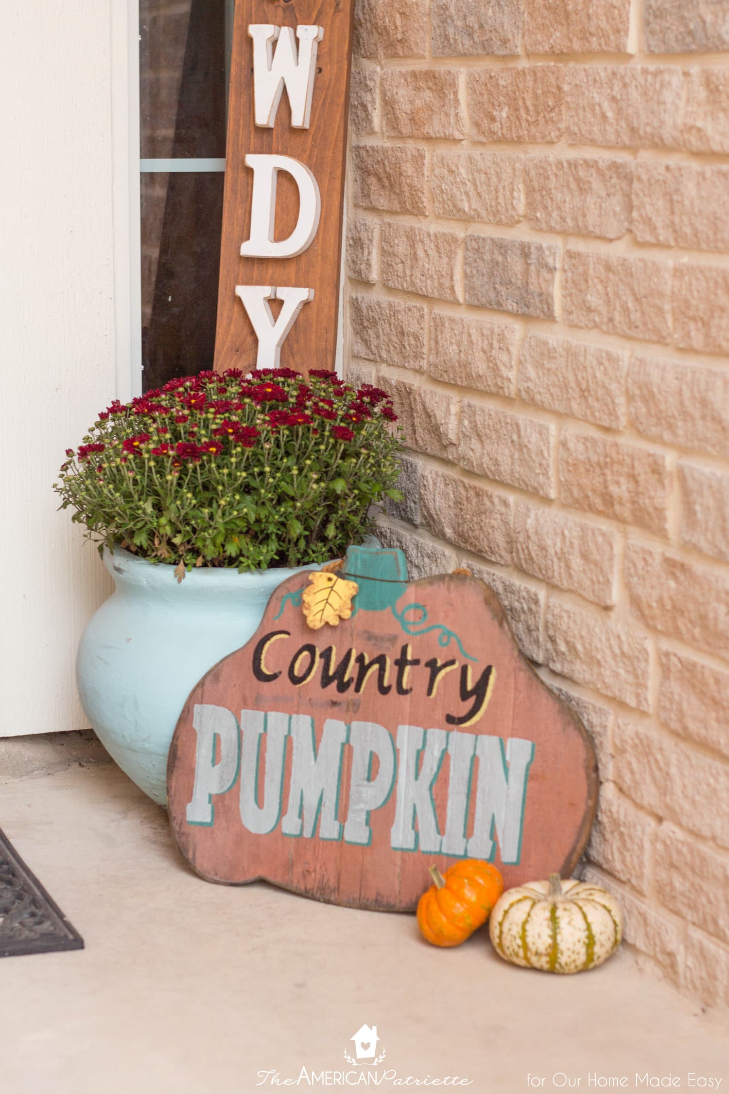 This fall themed front porch is packed with pops of color